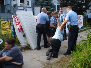 Protester from the MN Coalition for a People's Bailout is arrested trying to stop the eviction of Rosemary Williams.